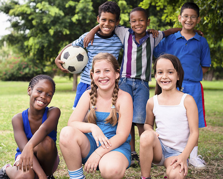 Three young girls and three young boys smile