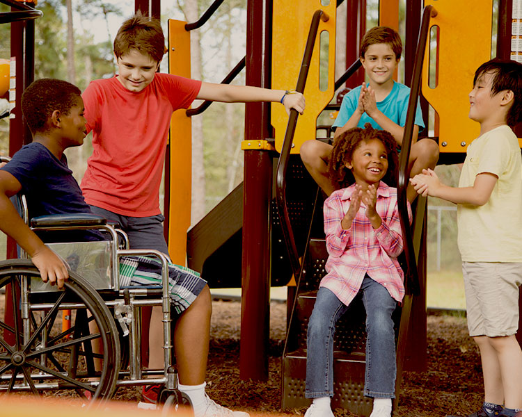 Kids smile and talk on a playground.