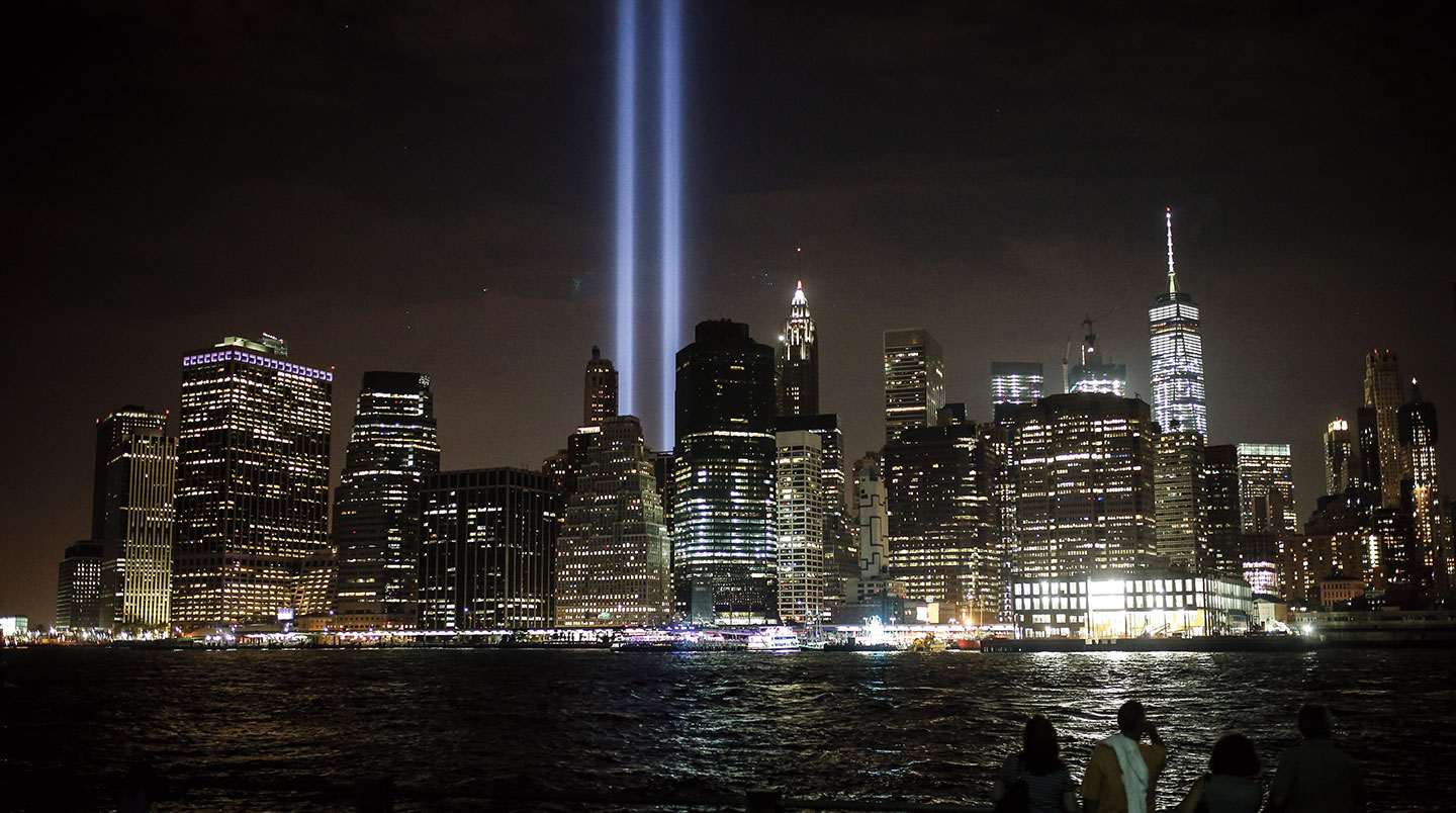 Two lights shine towards the night sky in New York