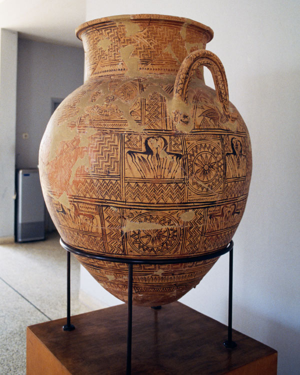 An ancient ceramic jug decorated with inscriptions and pictures.