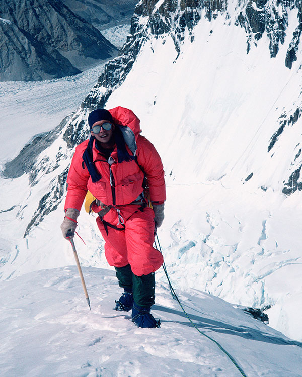 An explorer stands on a mountain.