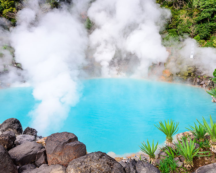 Steam rises from a small body of water.