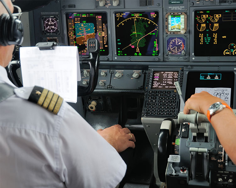 A pilot sits in an airplane cockpit.