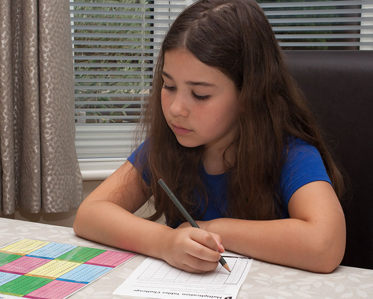 young girl at a desk doing her homework