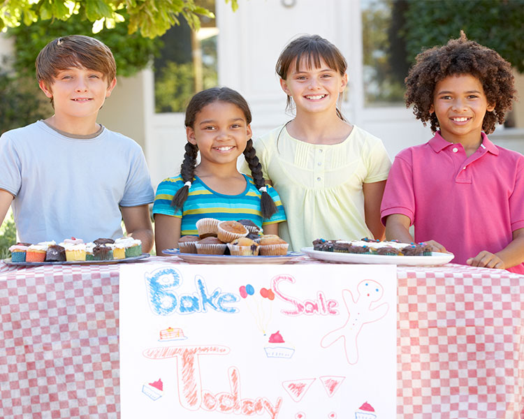 Four kids having a bake sale