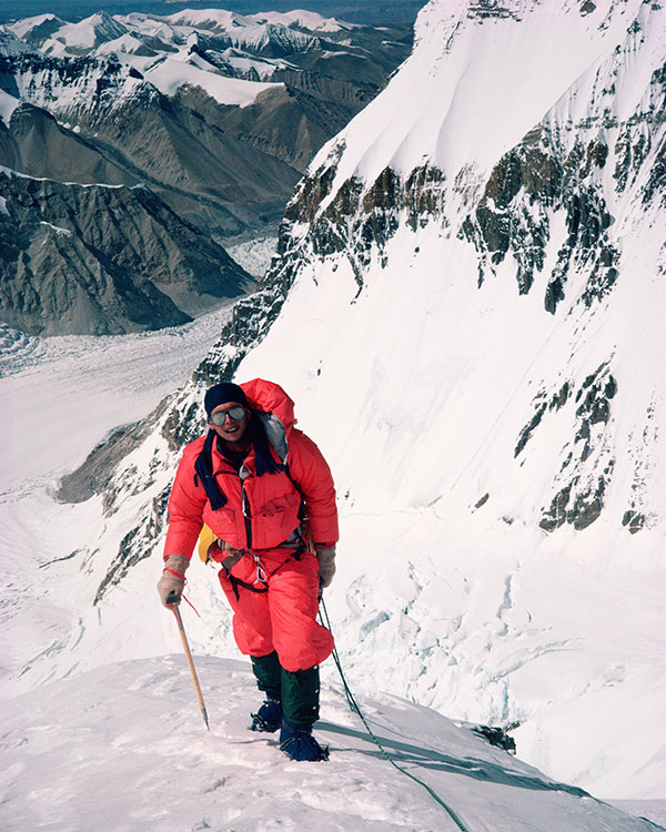 Photo of a person hiking up a snowy mountain