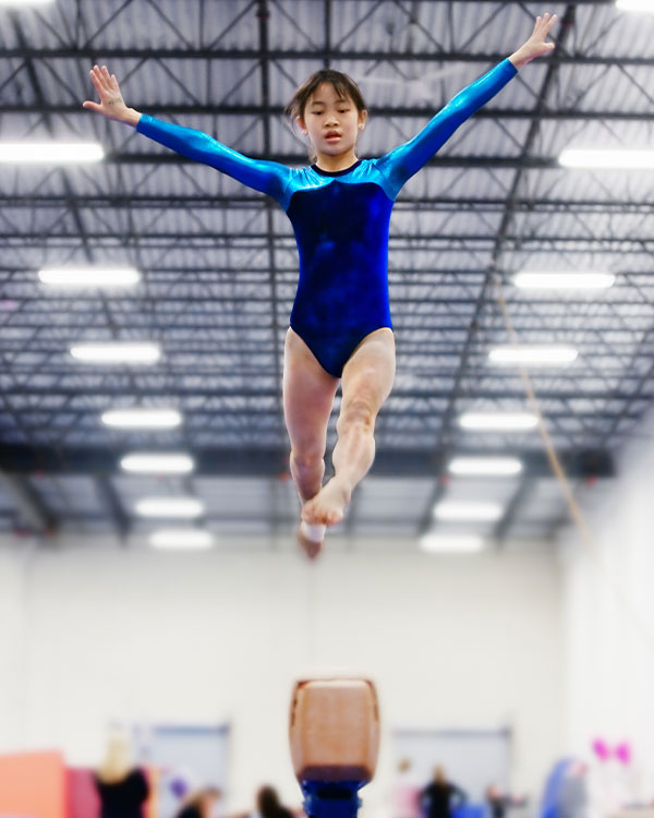 Photo of a gymnast performing on the balance beam