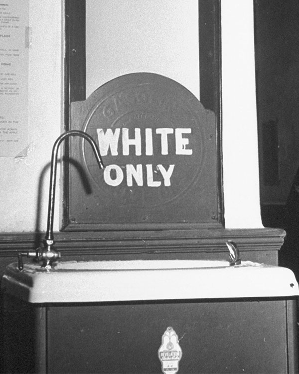 Black & white photo of a sink labeled, "White Only"