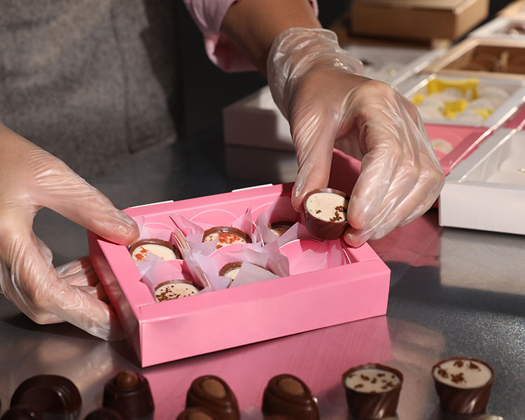 Image of a person packaging chocolates