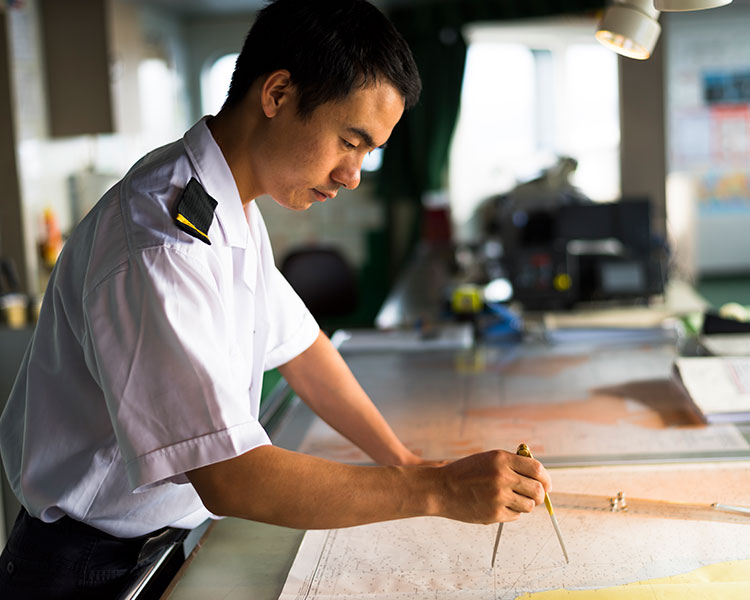 Person in uniform using tools to find the best course possible