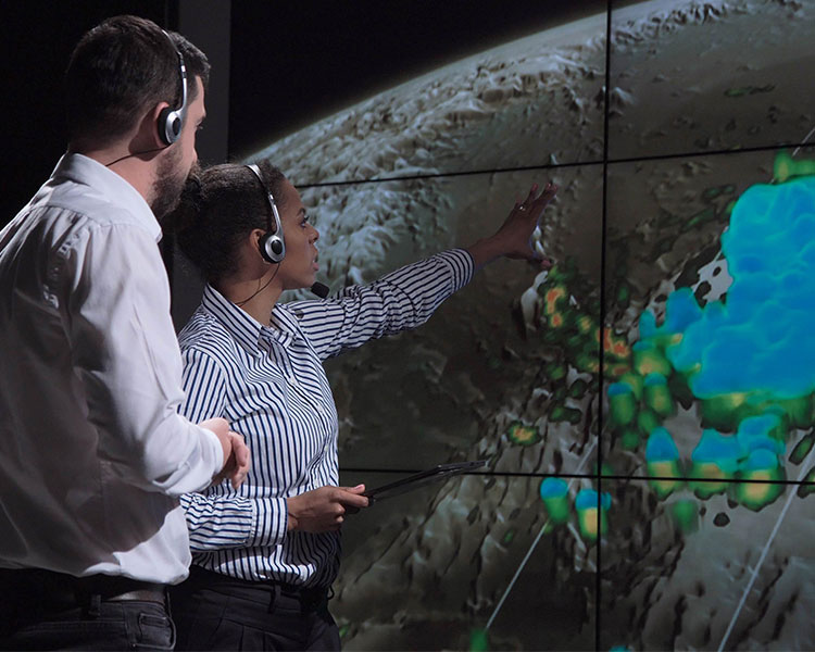 Two people analyzing an infrared satellite