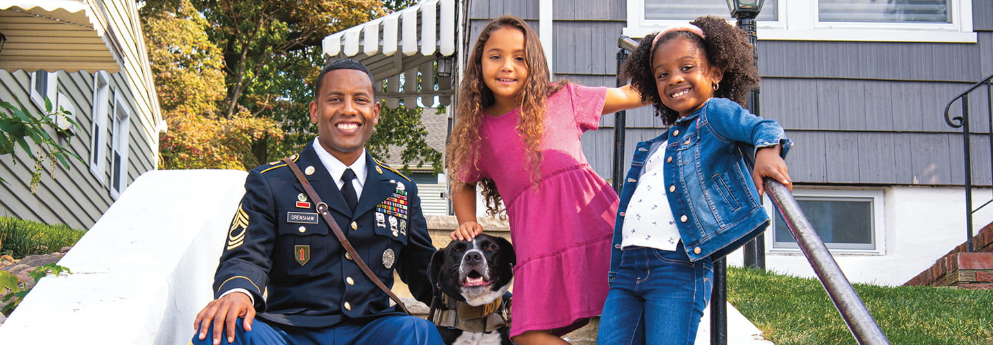 A veteran and his family posing with their service dog