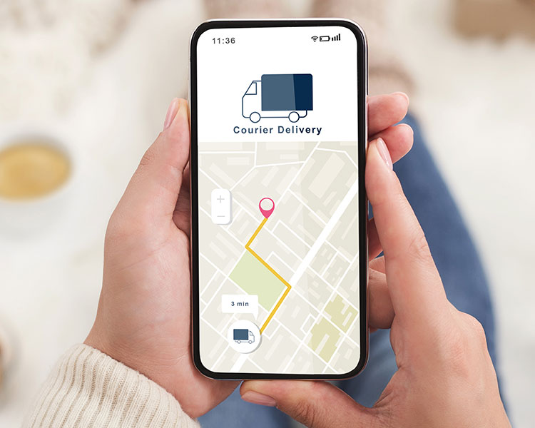 Image of a hand holding a cellphone showing an app where an item is being delivered