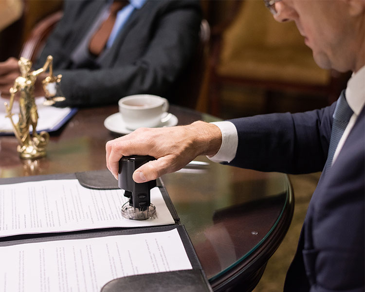 Image of a politician stamping an official document