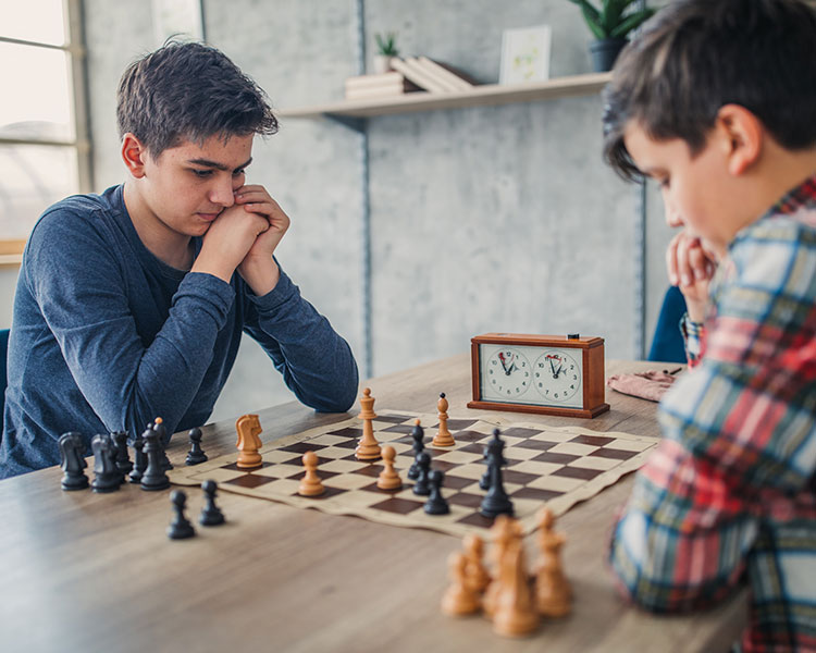 Image of two people playing chess