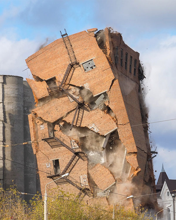 Photo of a tall building falling in on itself