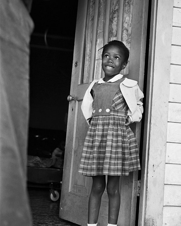 Black & white photo of a Black student about to attend a desegregated school