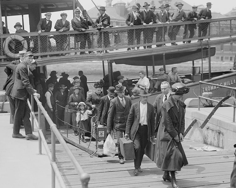 Black & white photo of immigrants getting off a boat