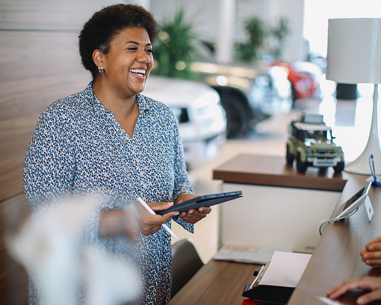 Image of an employee smiling and talking with a customer