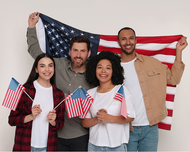 Photo of four American citizens posing with American flags