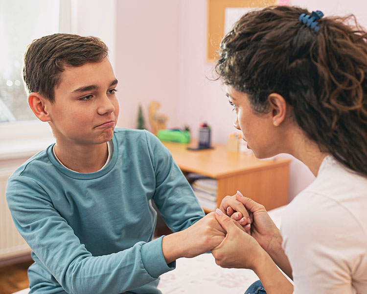 Photo of an upset child and an adult offering support