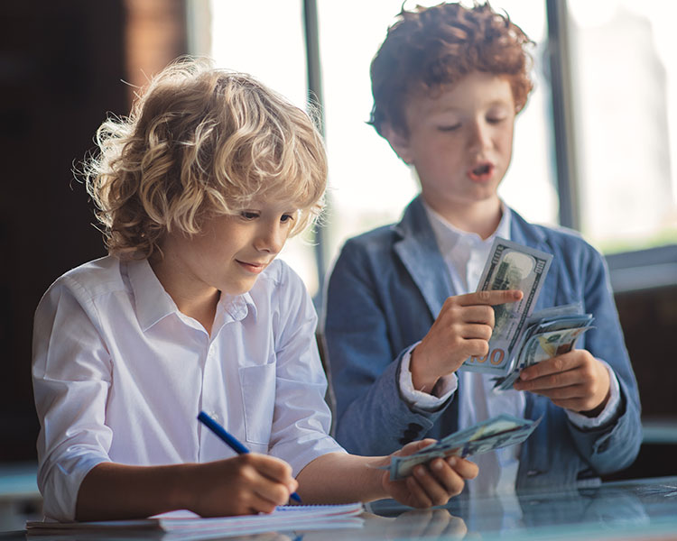 Photo of two kids counting paper money