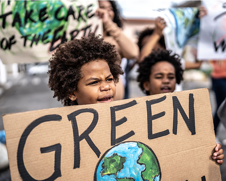 Photo of kids protesting for climate change with posters they made